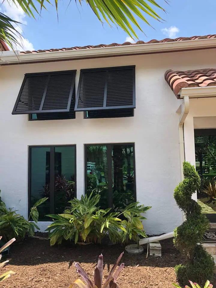 Bahama style shutters on mediterranean style house