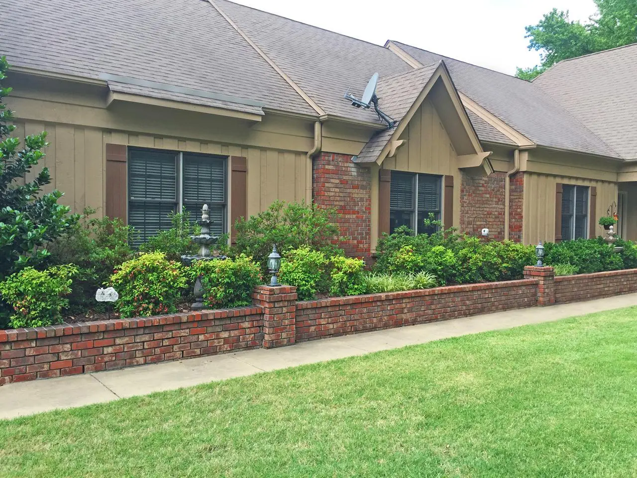 Board and batten shutters on brick and siding house
