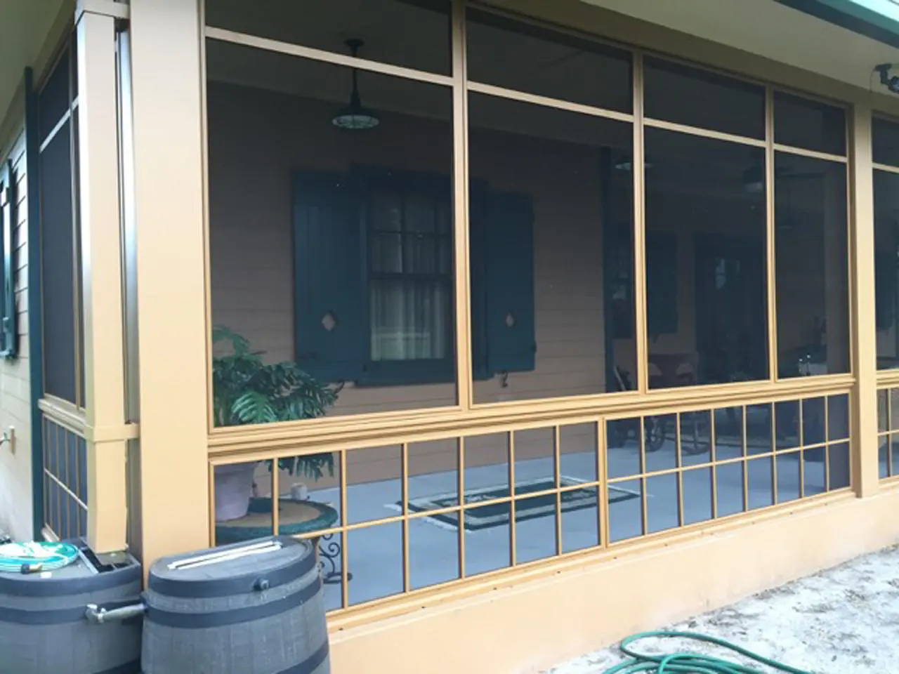 View of board and batten shutters through screened porch