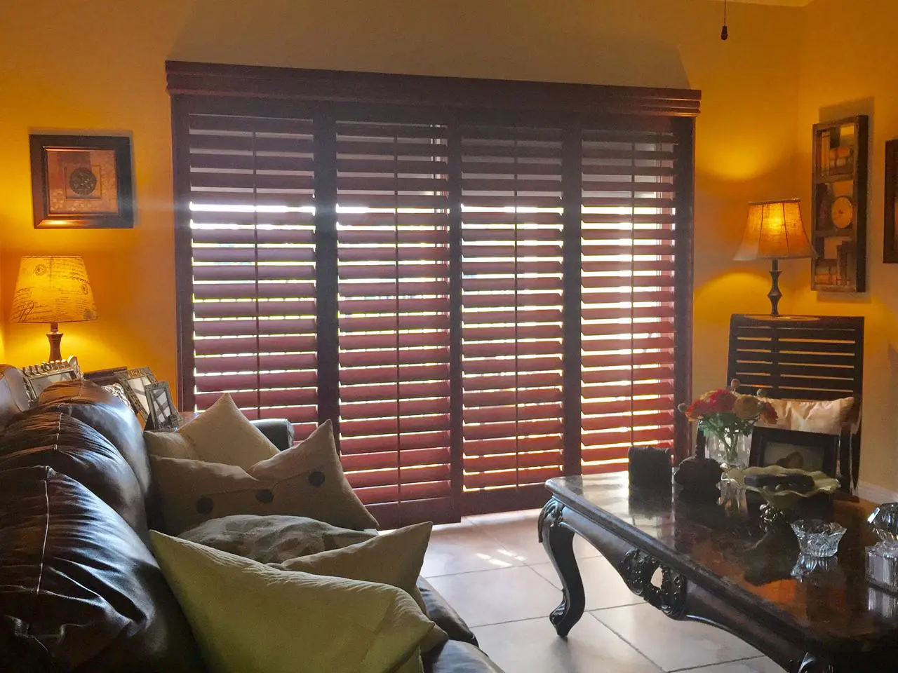 Stained wood interior shutters on sliding glass door
