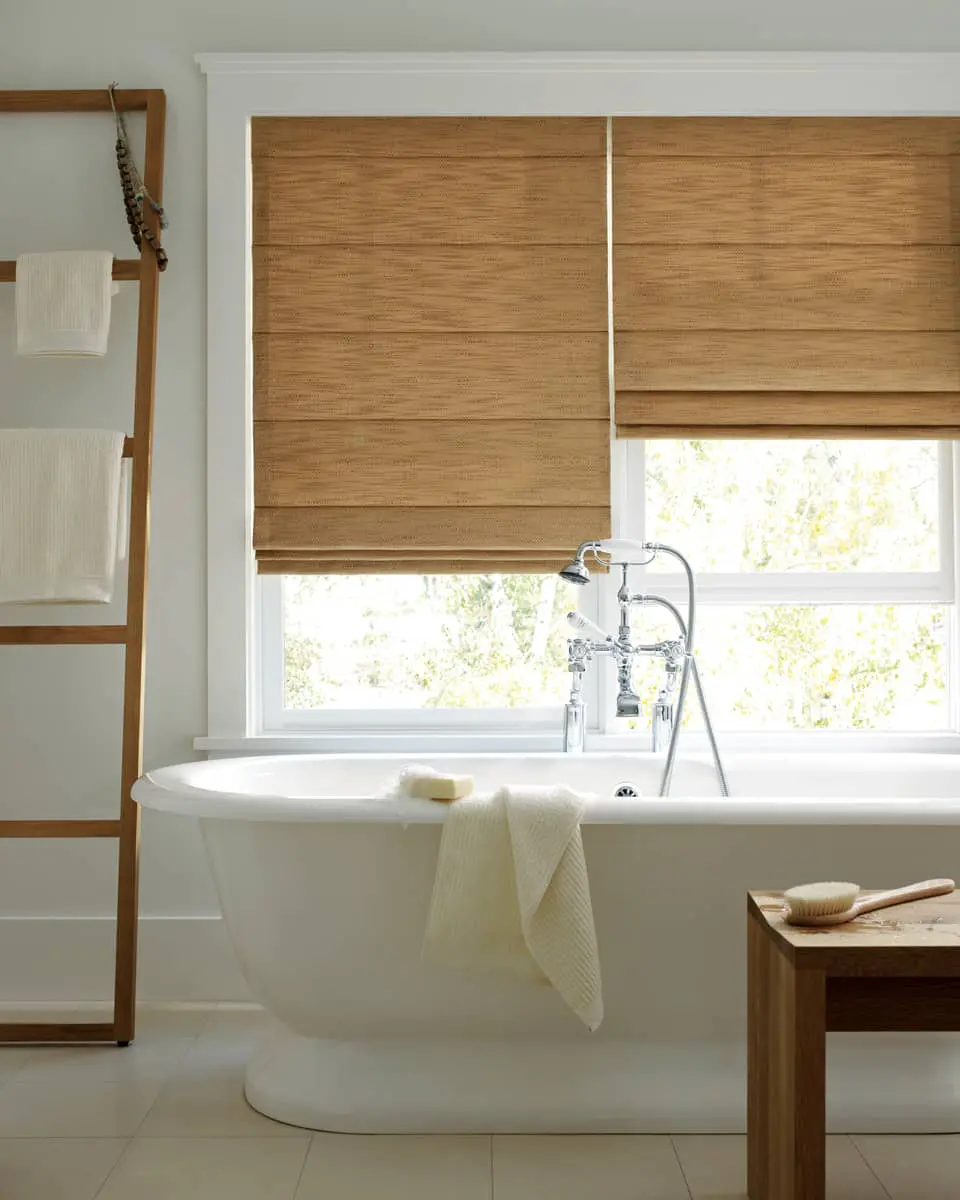 top-down, botton-up Roman shades on windows above built-in tub