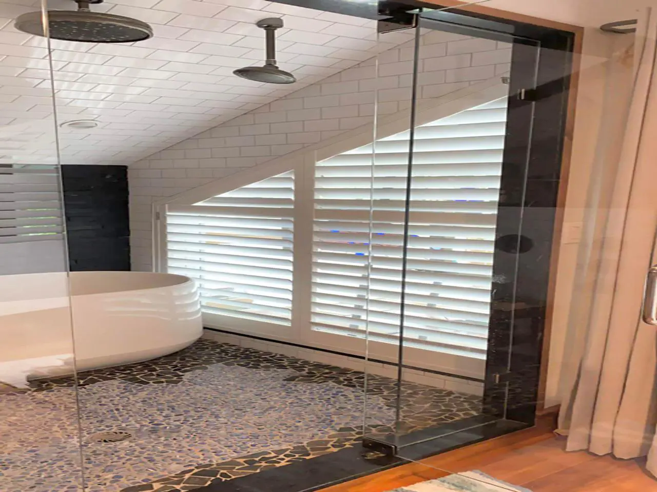 Bathroom with louverwood shutters in shower