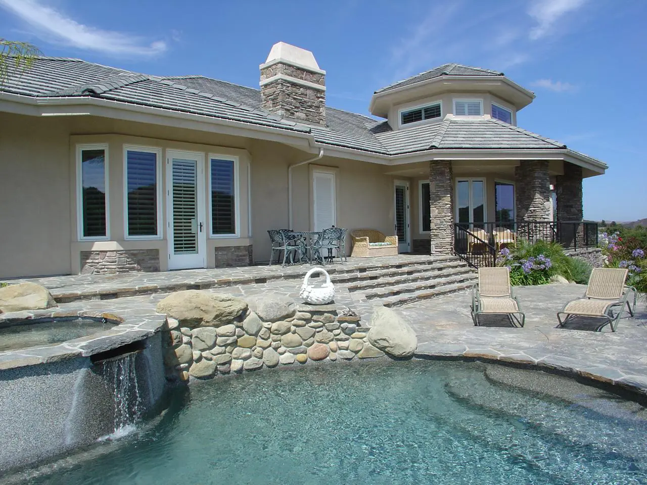 View from the swimming pool to French Door and windows with interior shutters