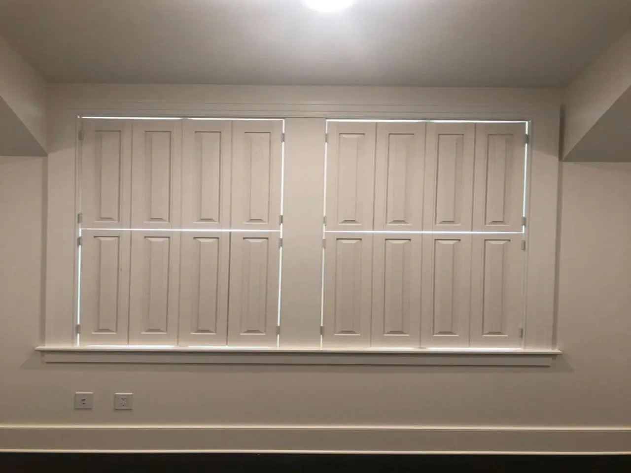 Raised panel shutters on a double window