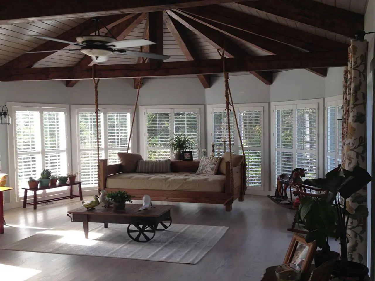 plantation shutters on windows in a sun room