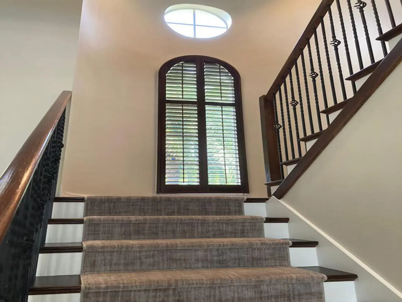 Stained arched shutters on stairway