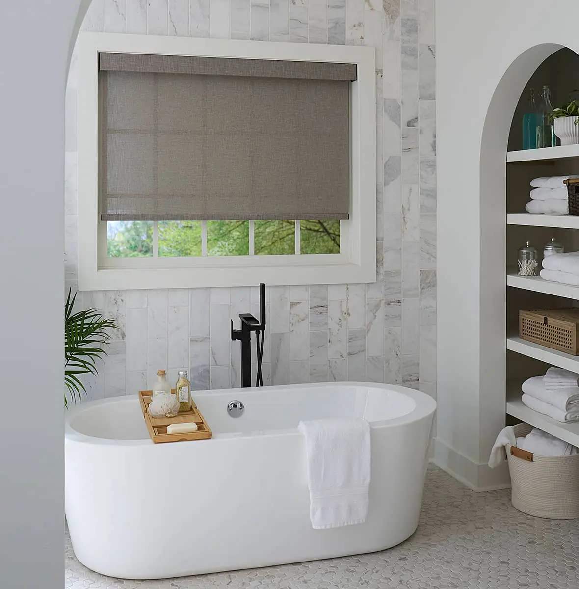 roller shades on large window above a bath tub