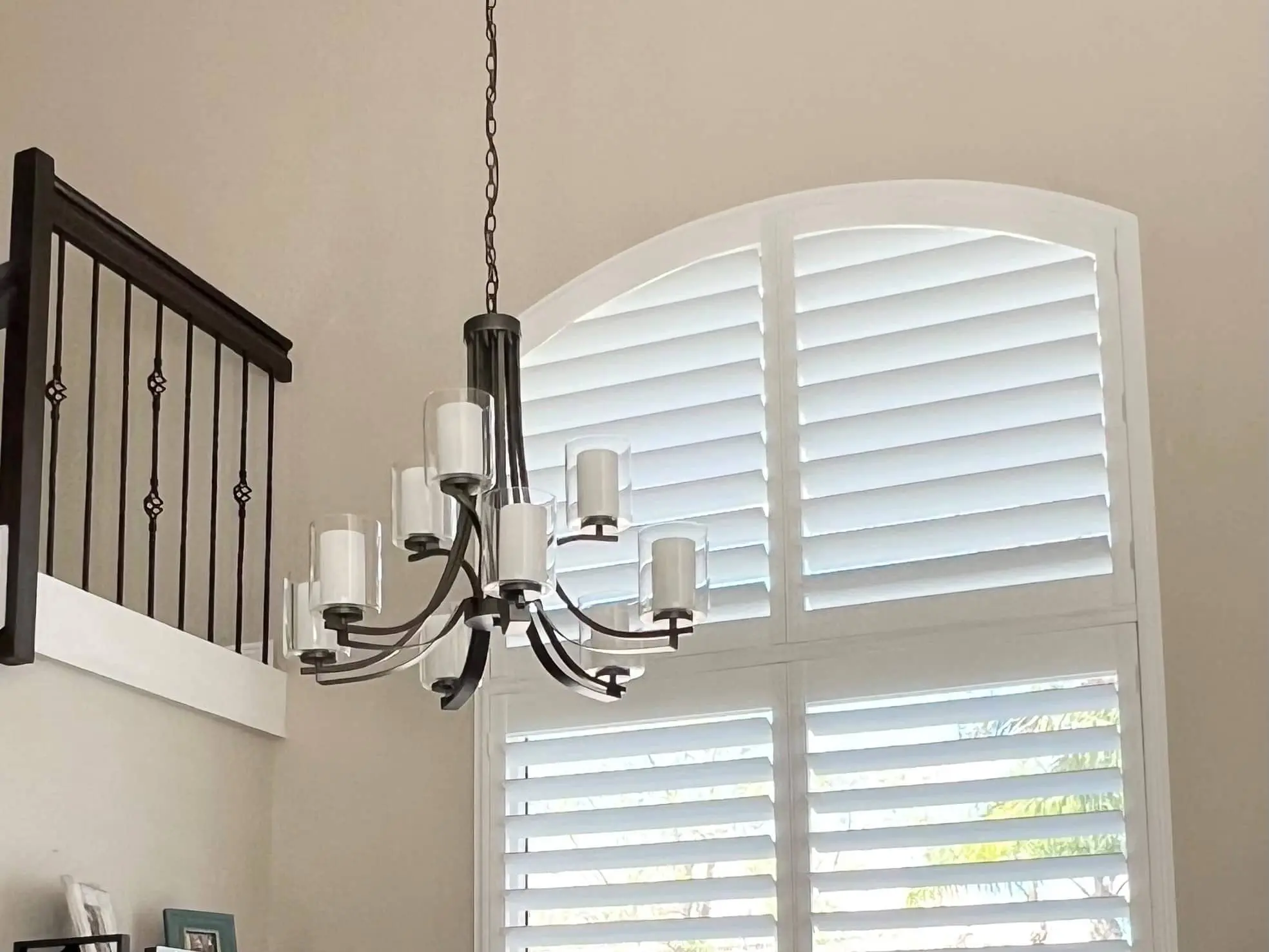 shutters with hidden tilt rod on large, arch-topped window