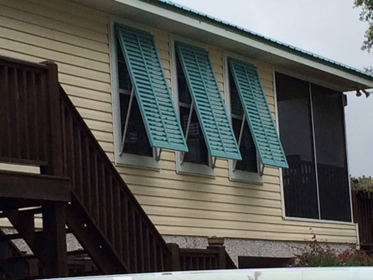 Bahama shutters on house with siding