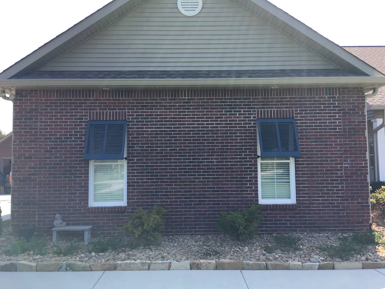 Bahama shutters on a brick house