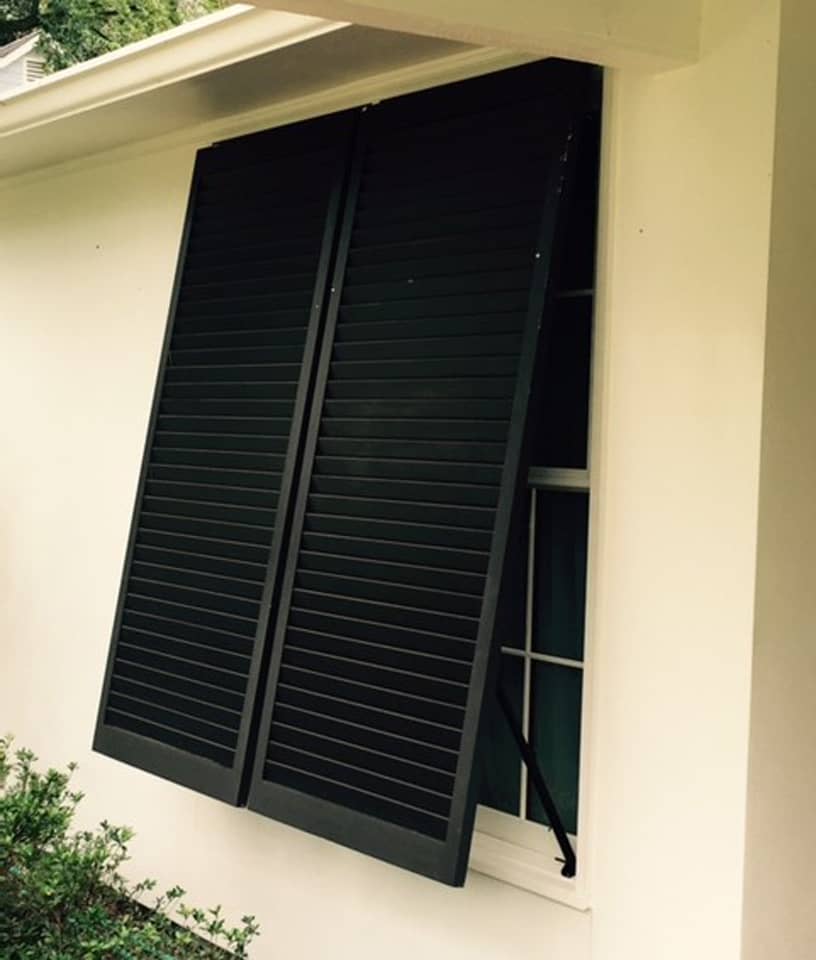 Bahama shutters on a stucco house