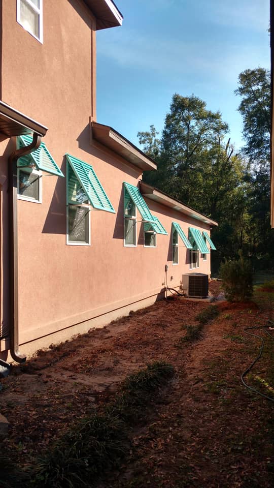 Bahama shutters on a stucco house