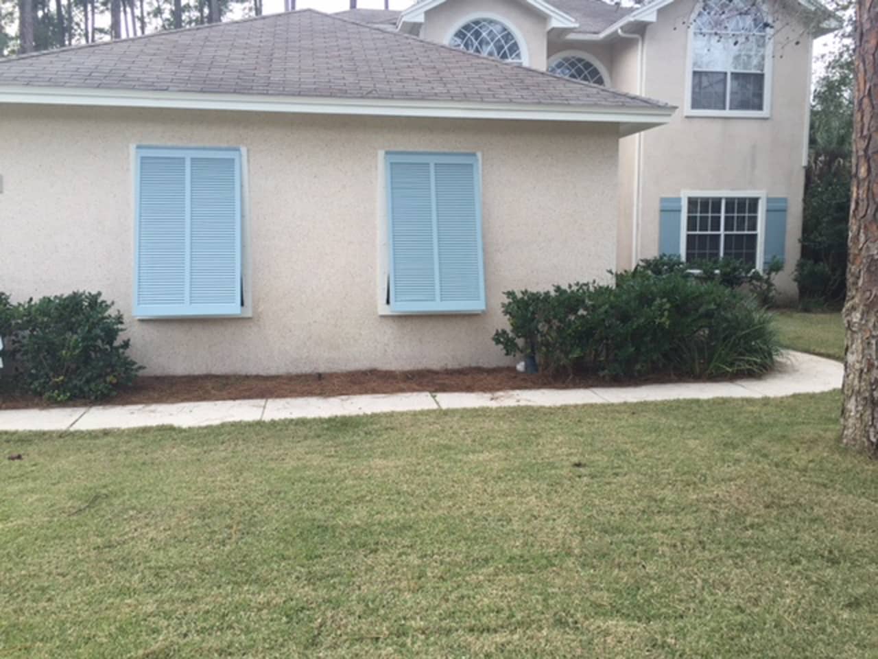 Bahama shutters on a stucco house