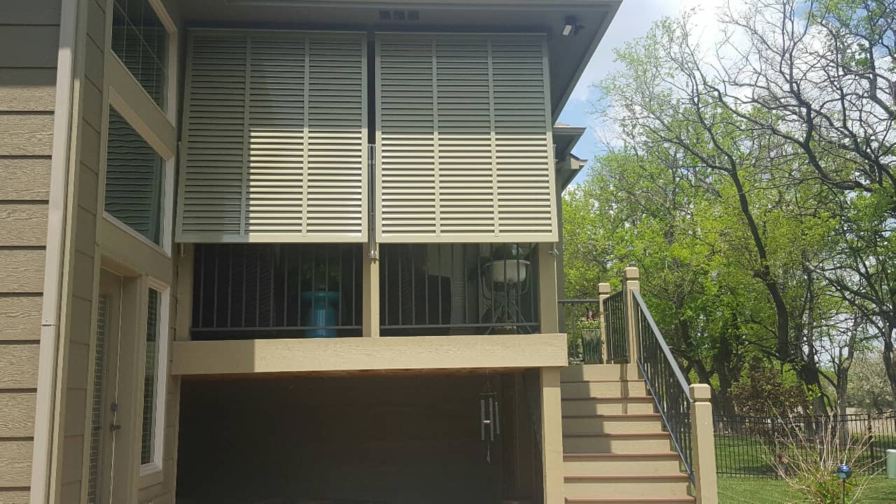 Bahama shutters on a porch with stairs