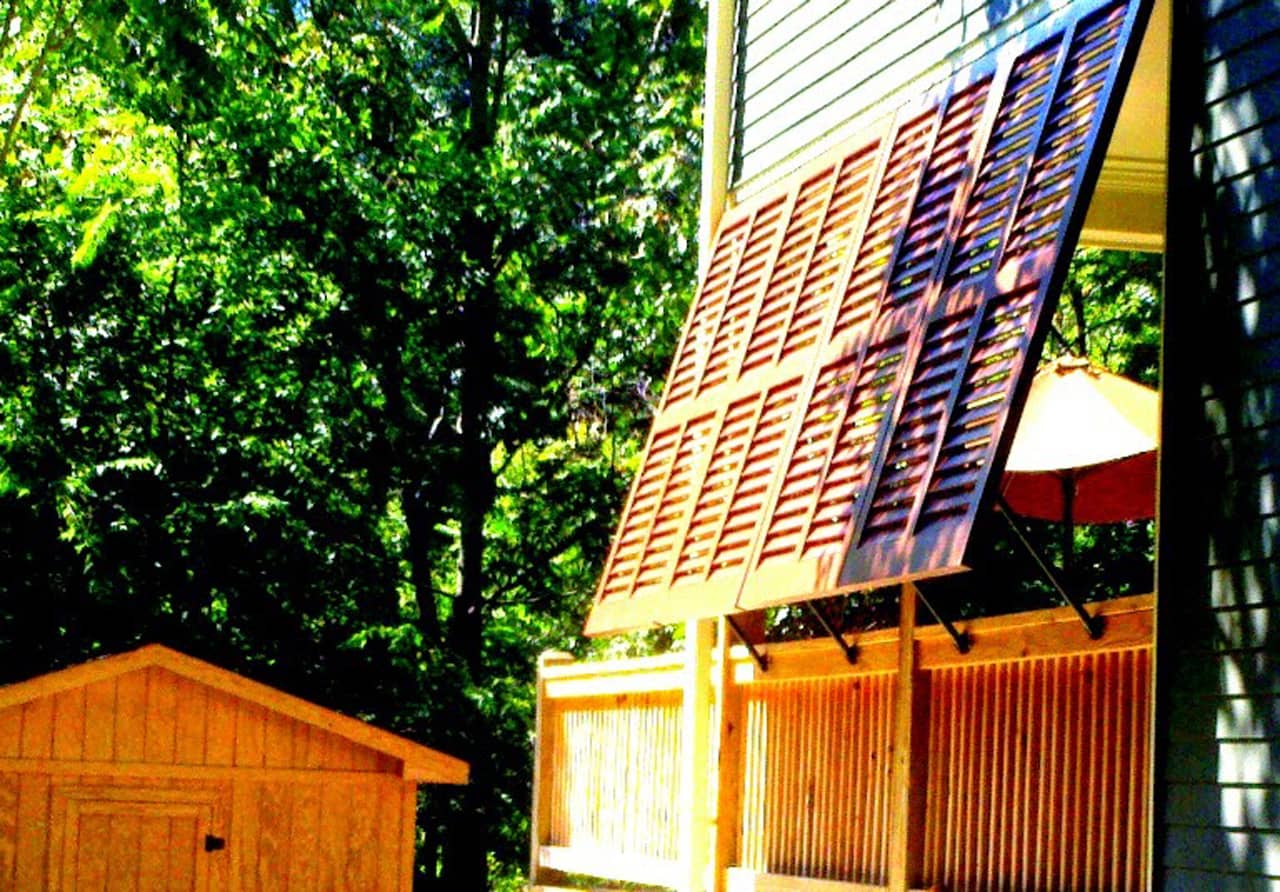 Stained Bahama style shutters on a deck