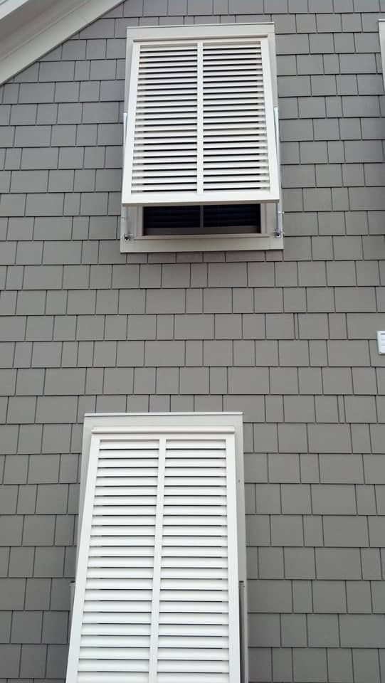 White Bahama shutters on shaker house