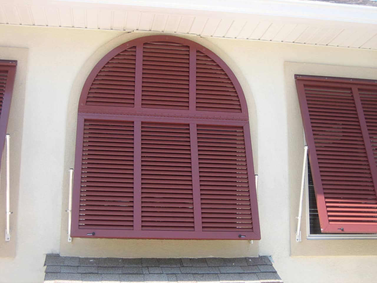 Arched Bahama shutters on a house