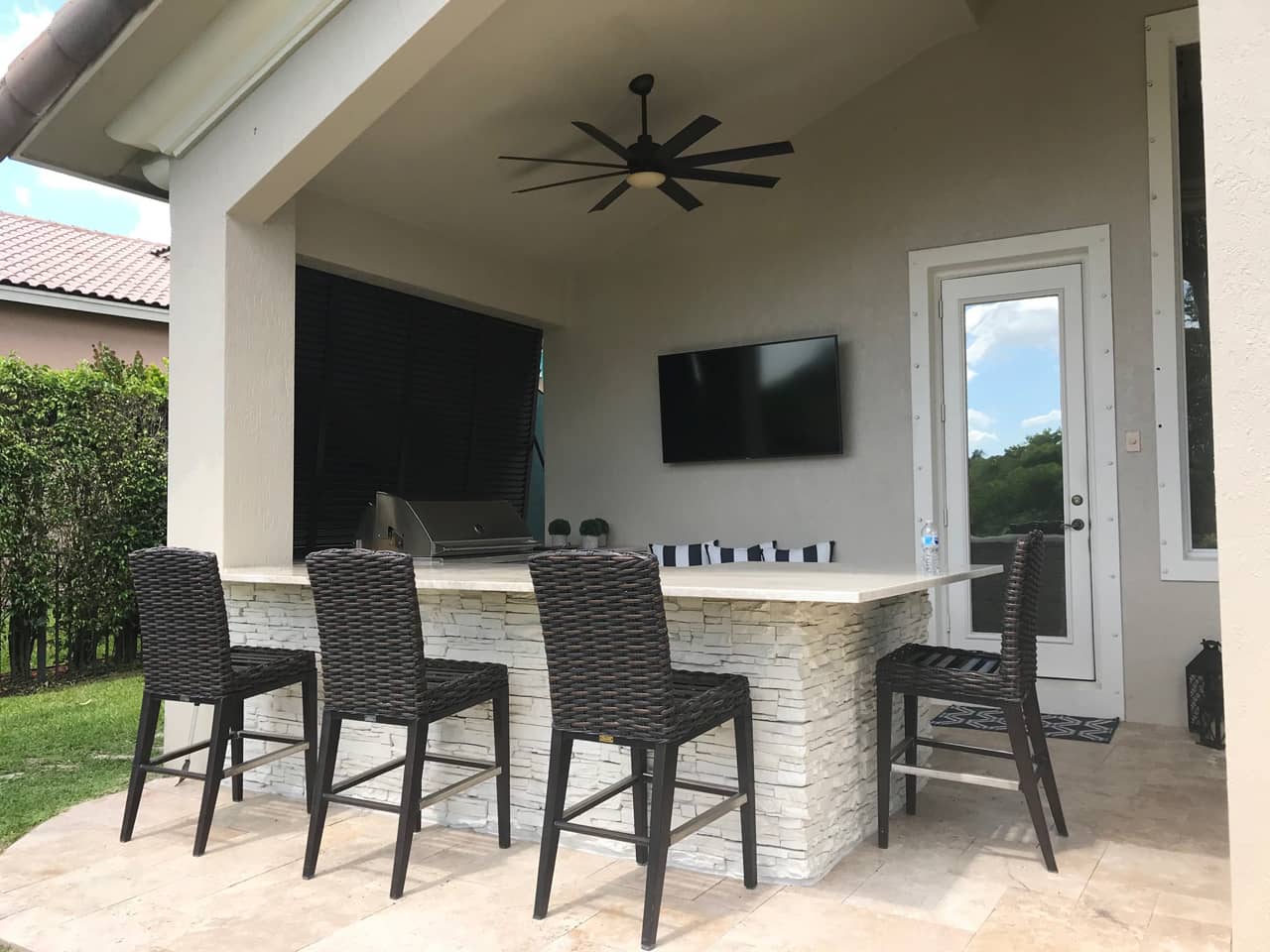 Outdoor kitchen with Bahama shutters