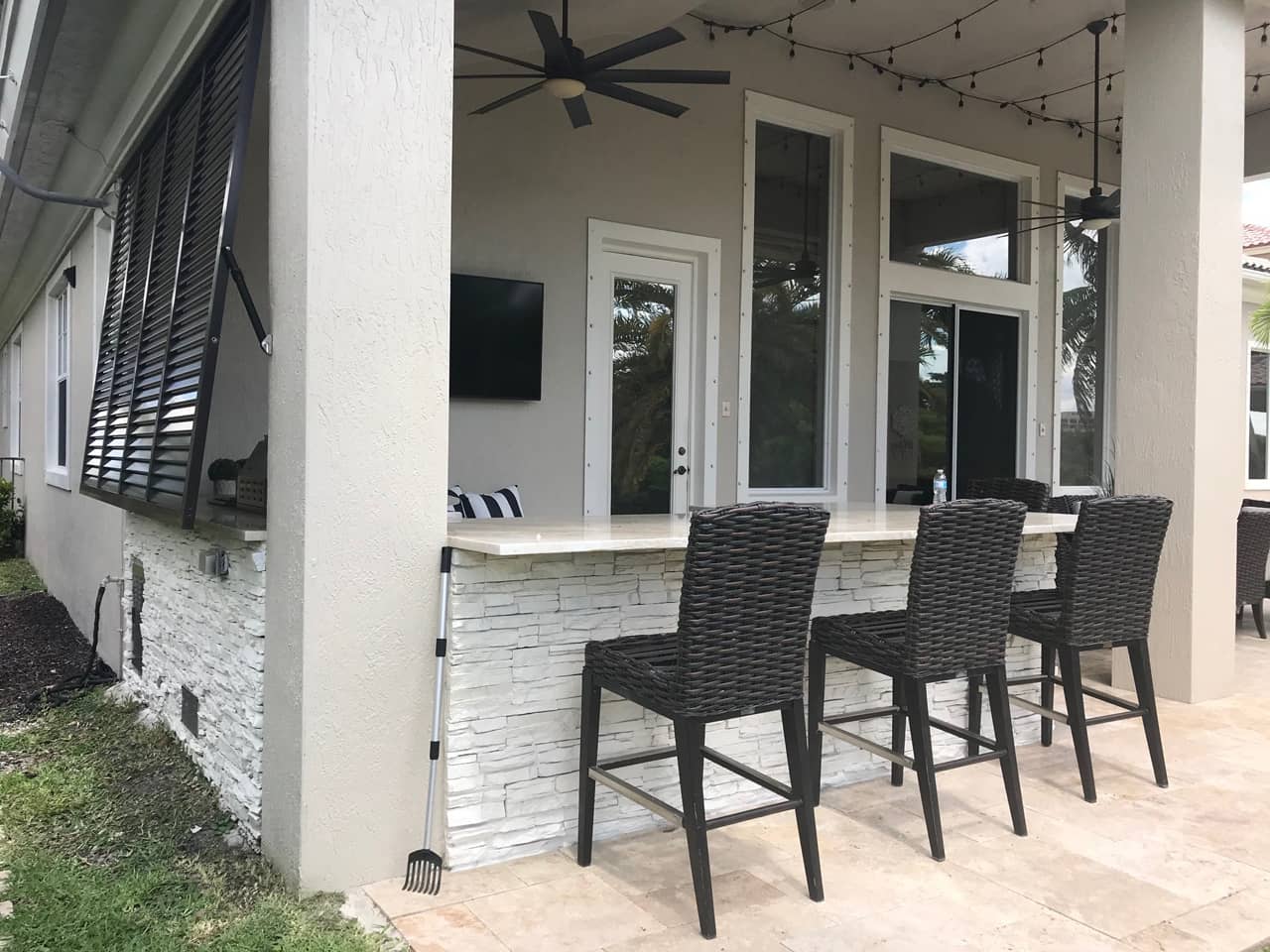 Outdoor kitchen with Bahama shutters