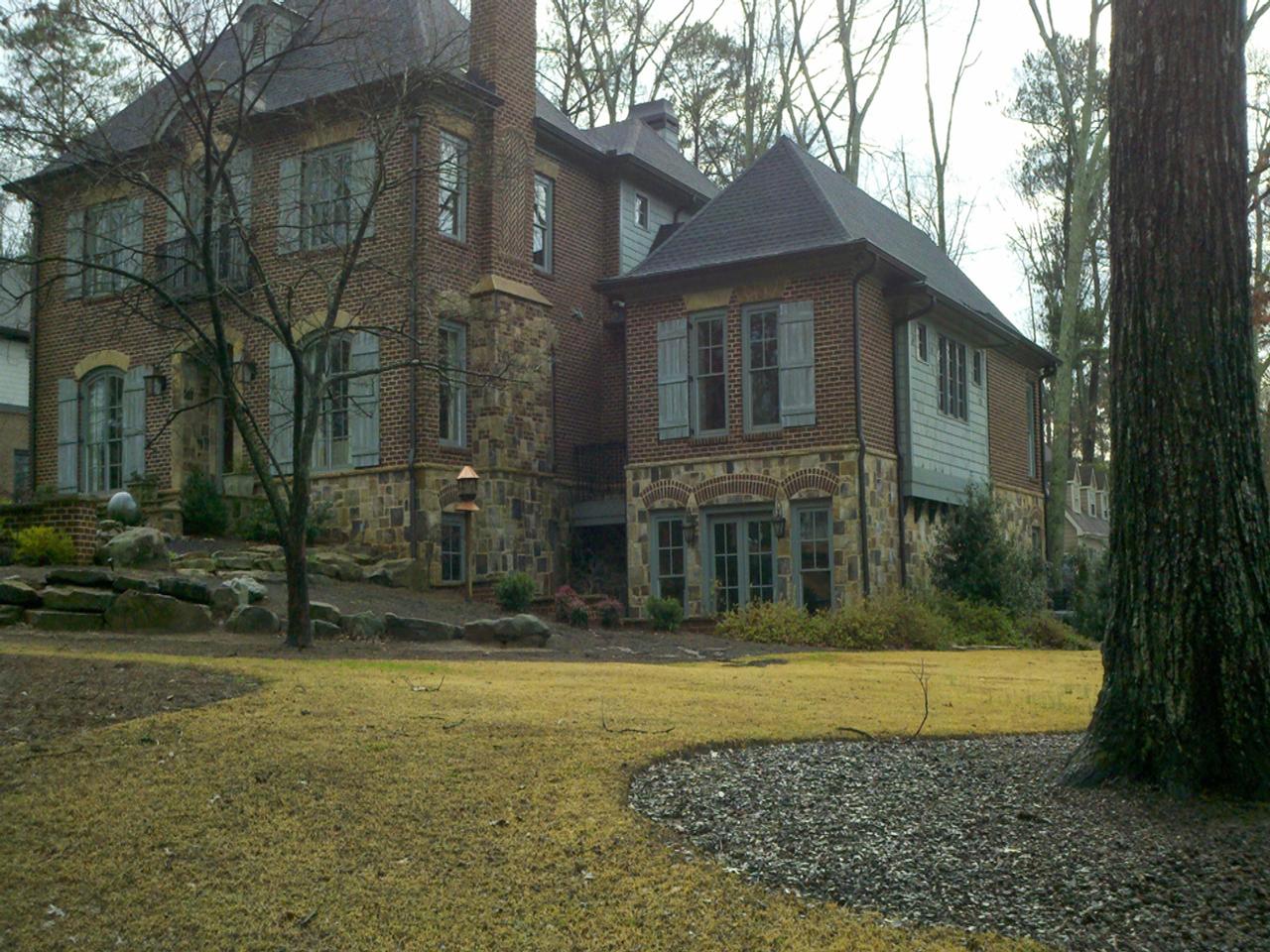 Beautiful home with arched and regular board and batten shutters