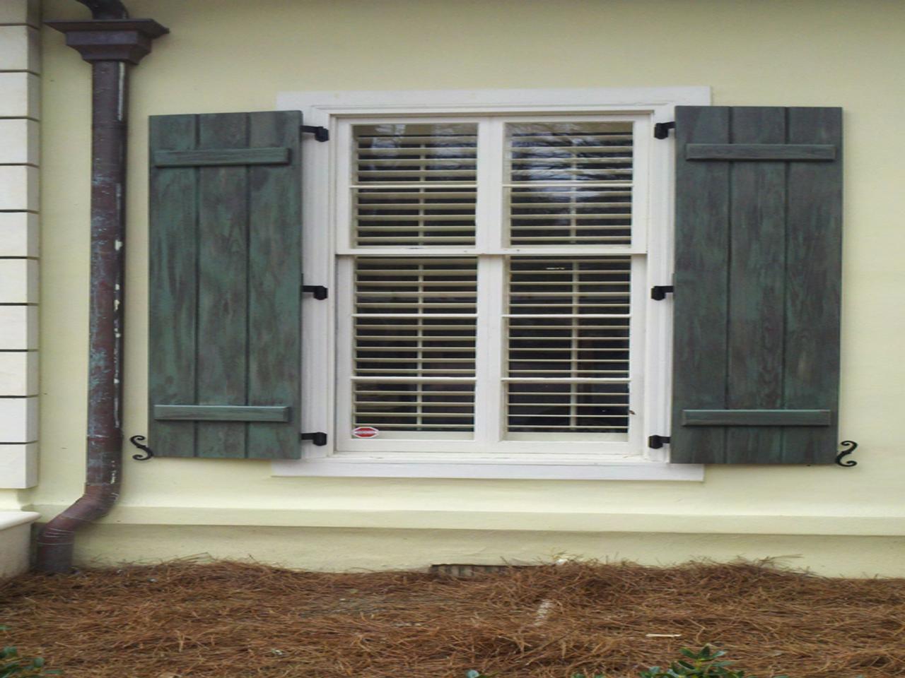 Board and batten shutters with hinges and shutter dogs