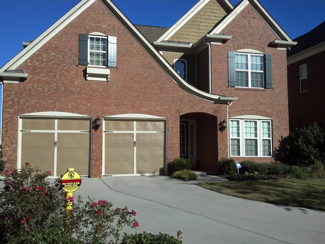 Board and batten shutters on a brick house