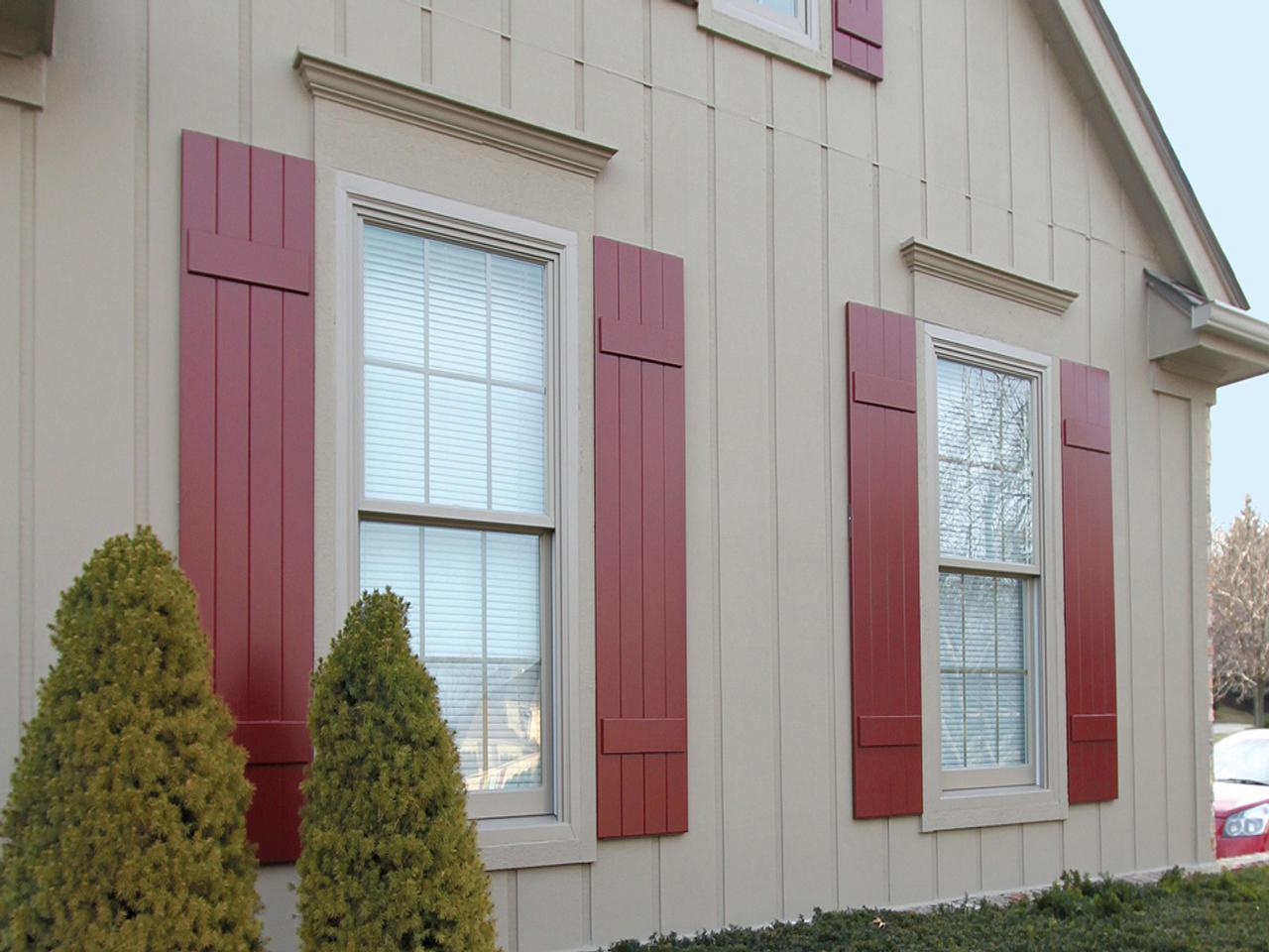 brick red Board and batten shutters on house