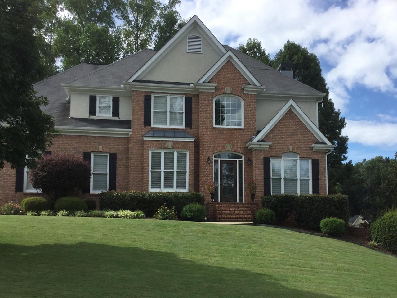 Traditional brick house with board and batten shutters