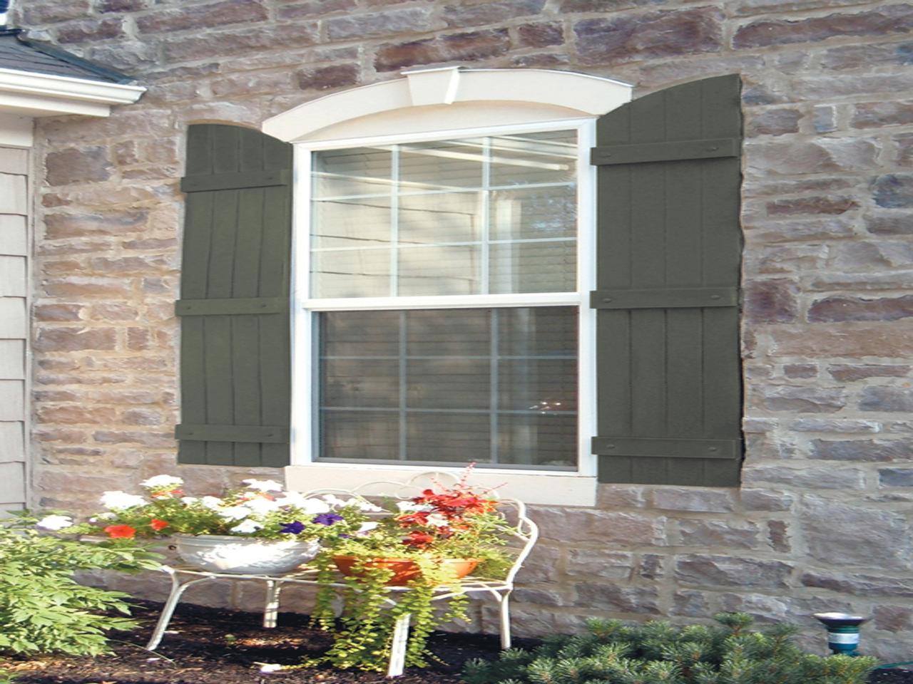 Arched board and batten shutters on stone house