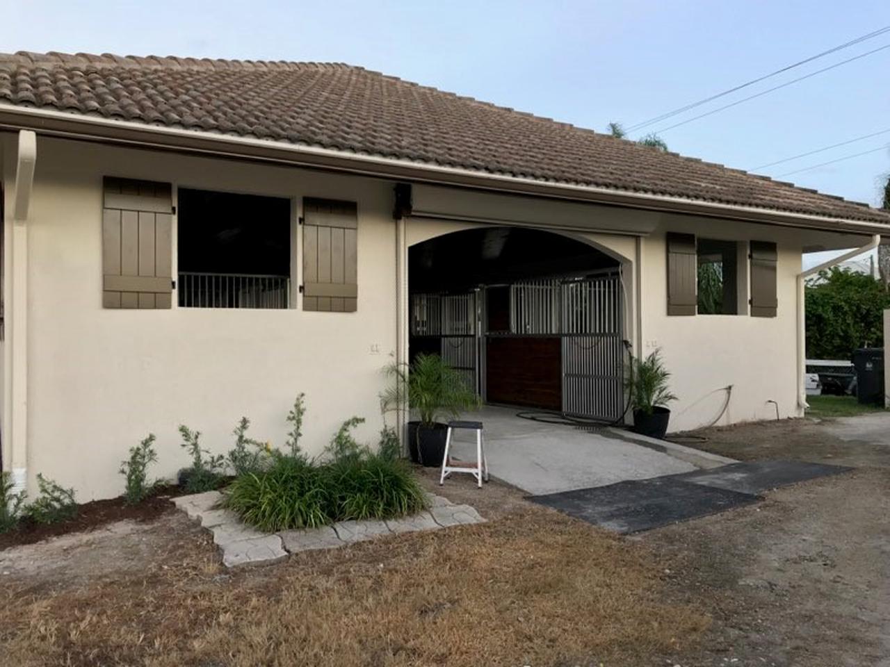 Board and batten shutters on mediterranean style stucco house