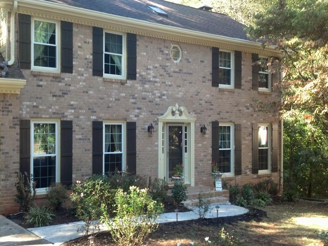 Traditional brick house with board and batten shutters