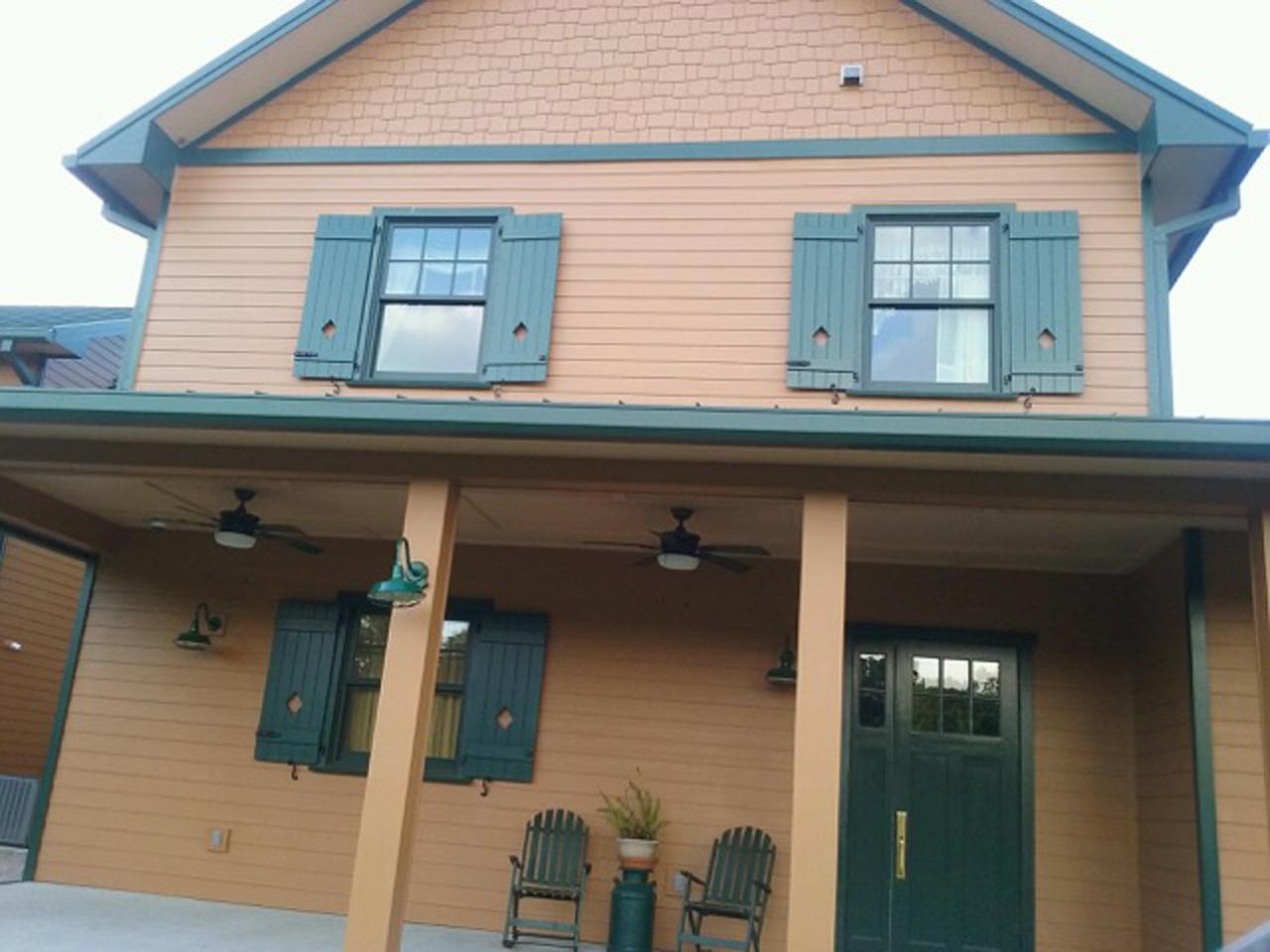 Operable board and batten shutters on house with siding