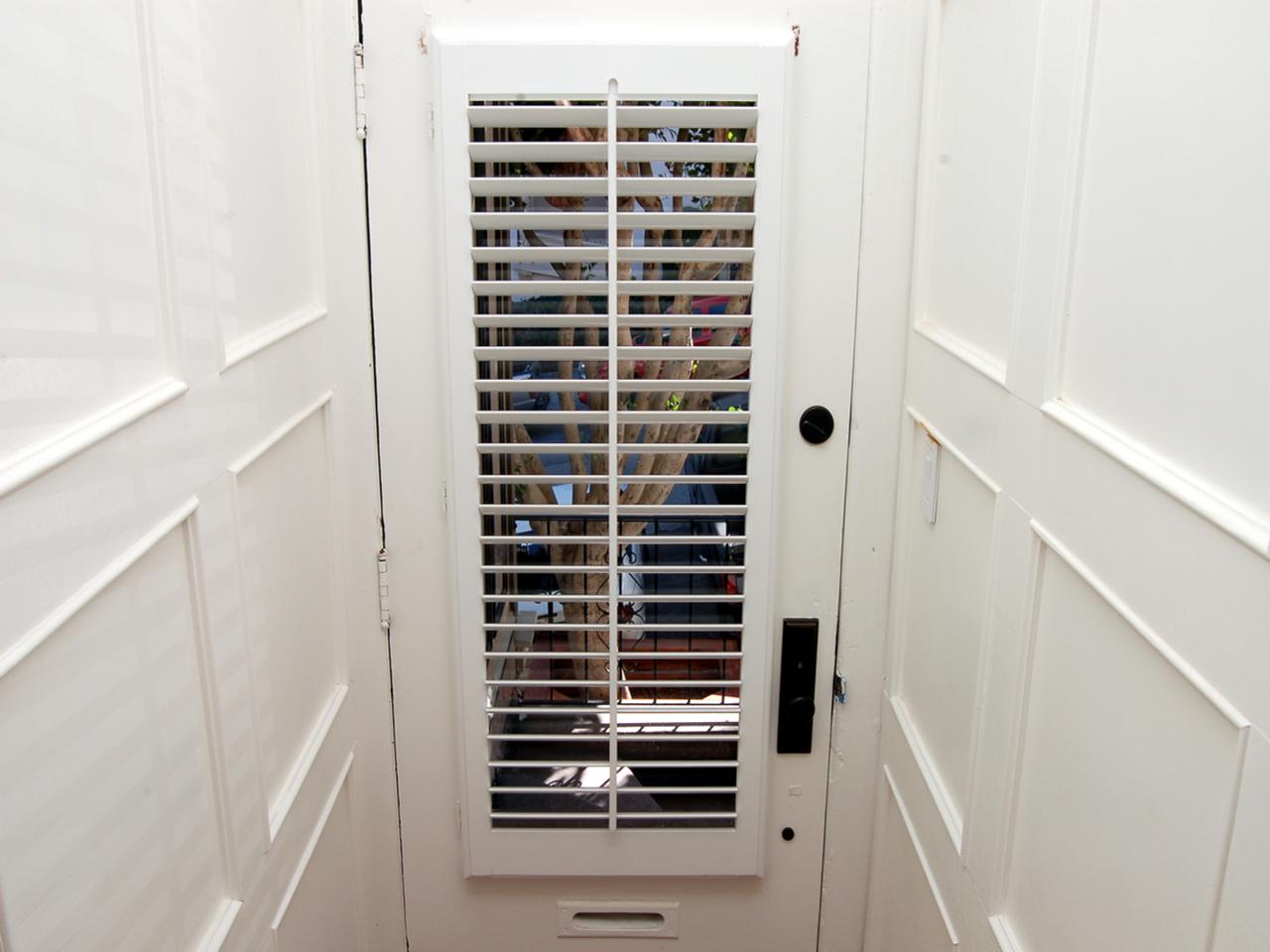 Plantation shutters on a door with glass