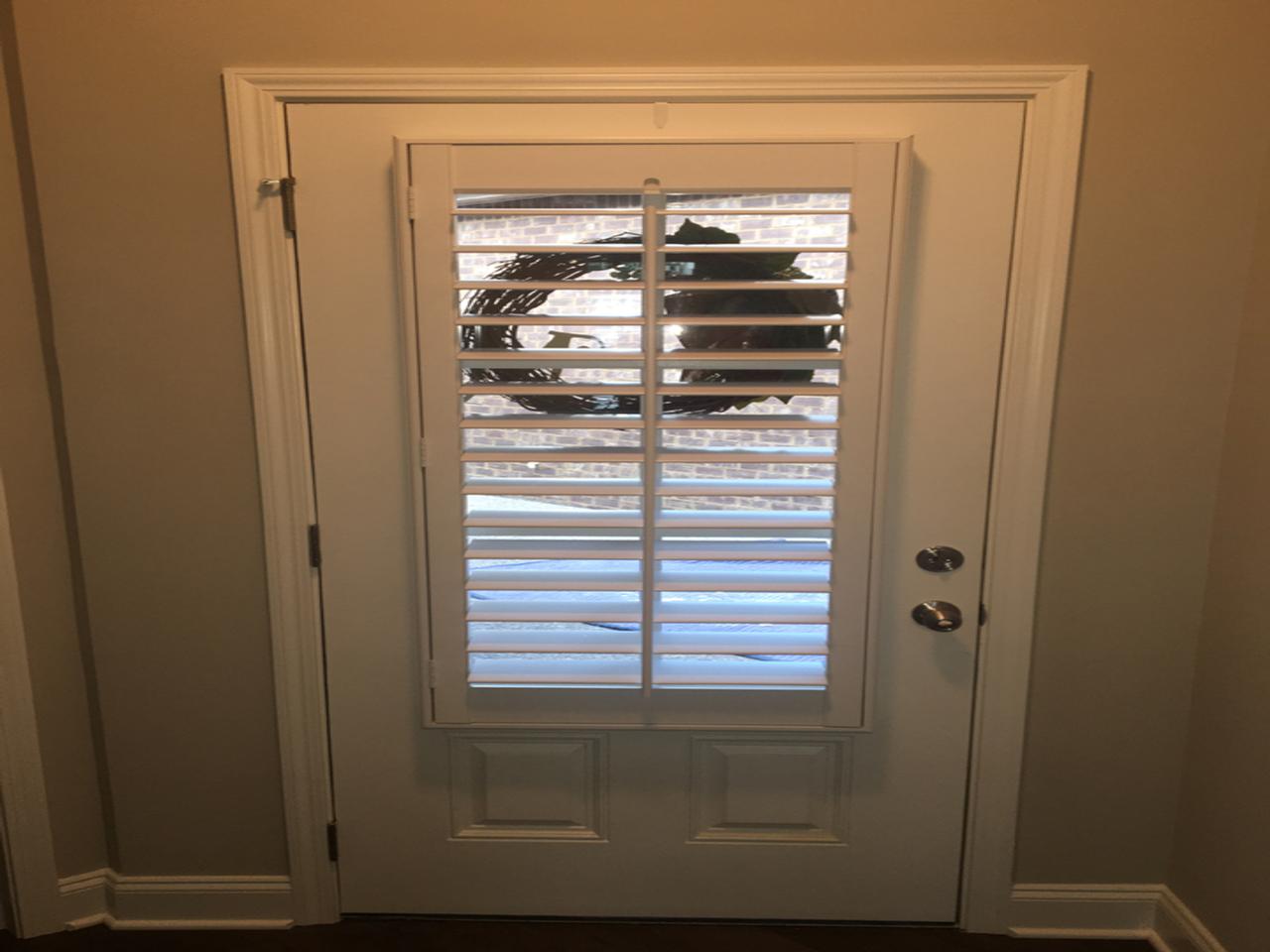 Door with plantation shutters on the glass portion