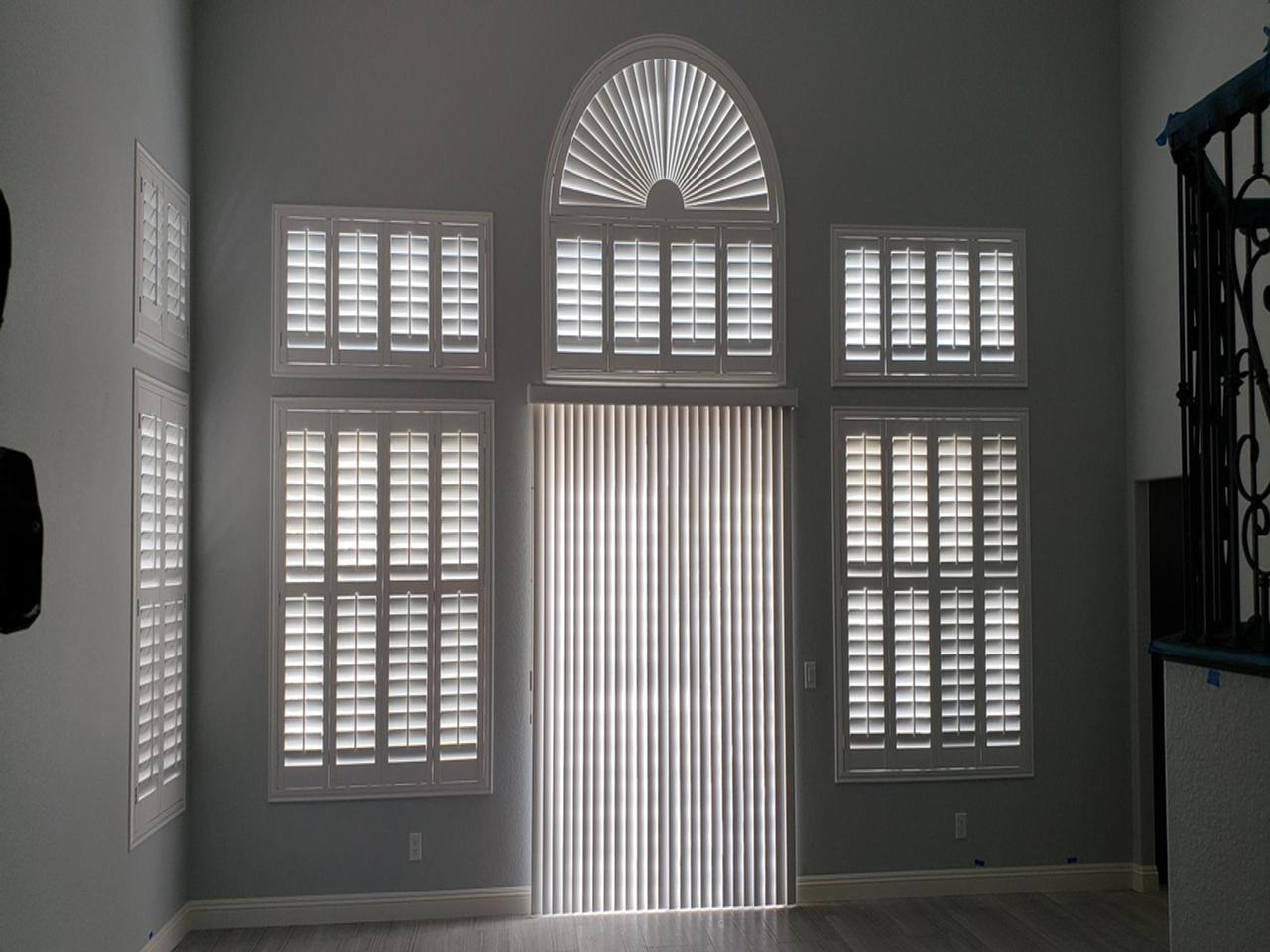 Huge wall of windows with arched windows with shutters