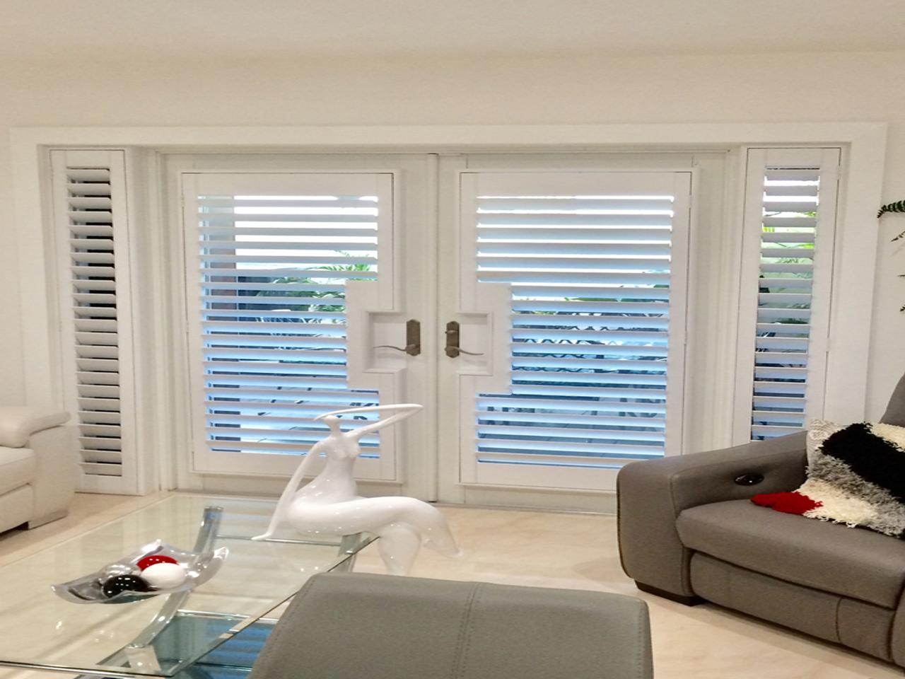 Contemporary room with plantation shutters on French doors with sidelights