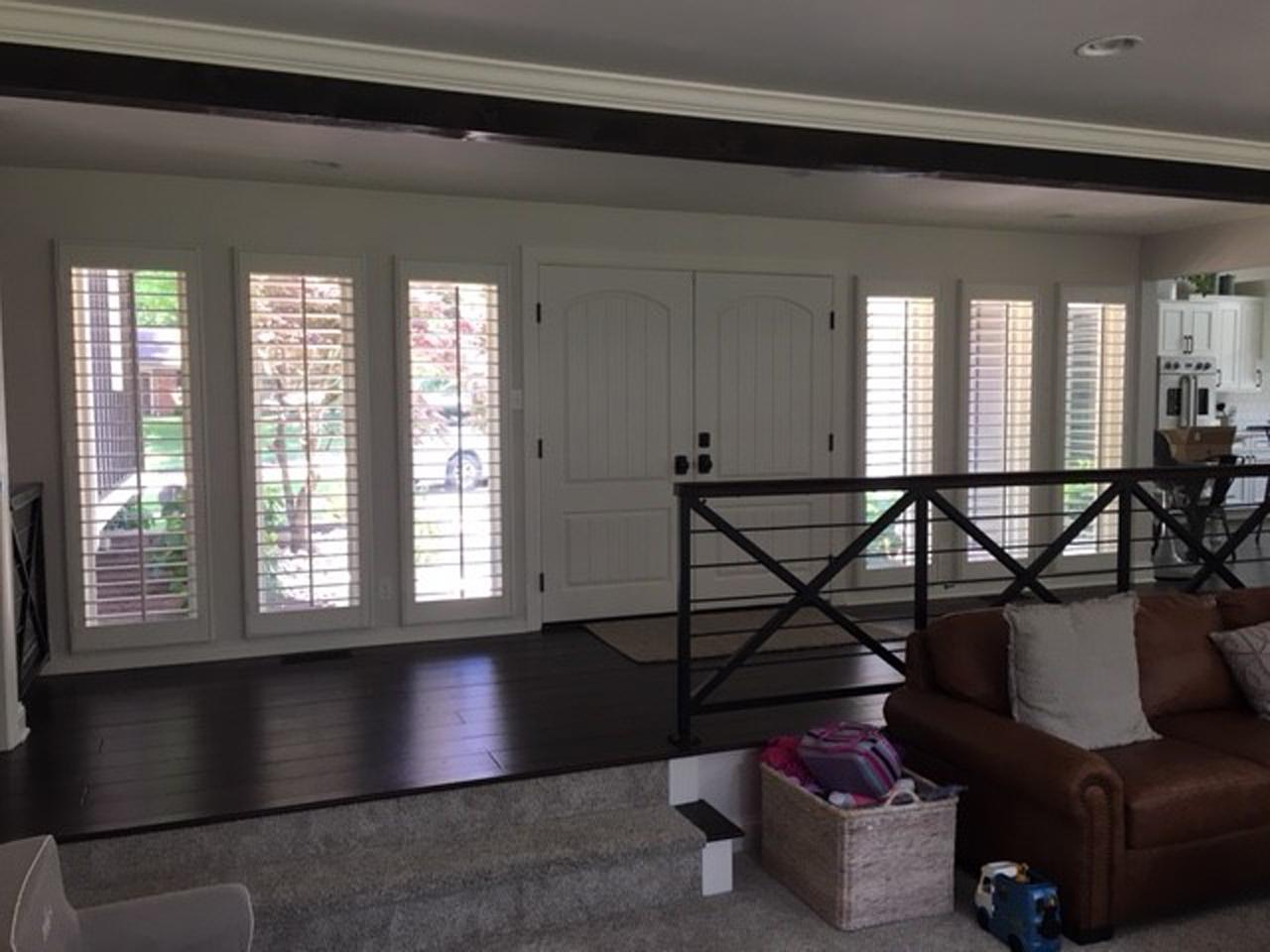 Windows by double front doors with interior shutters