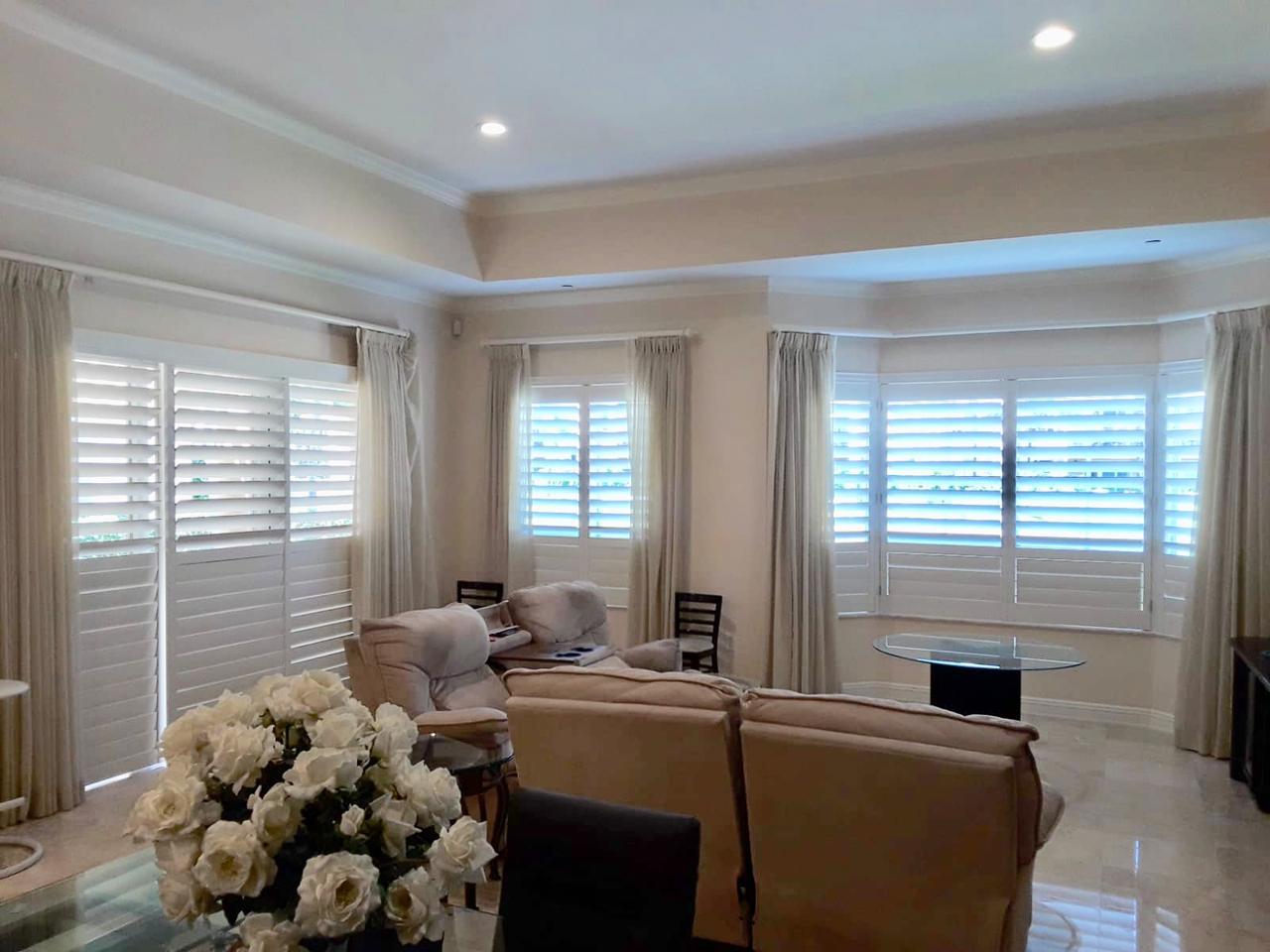 Sliding glass doors and bay window with plantation shutters