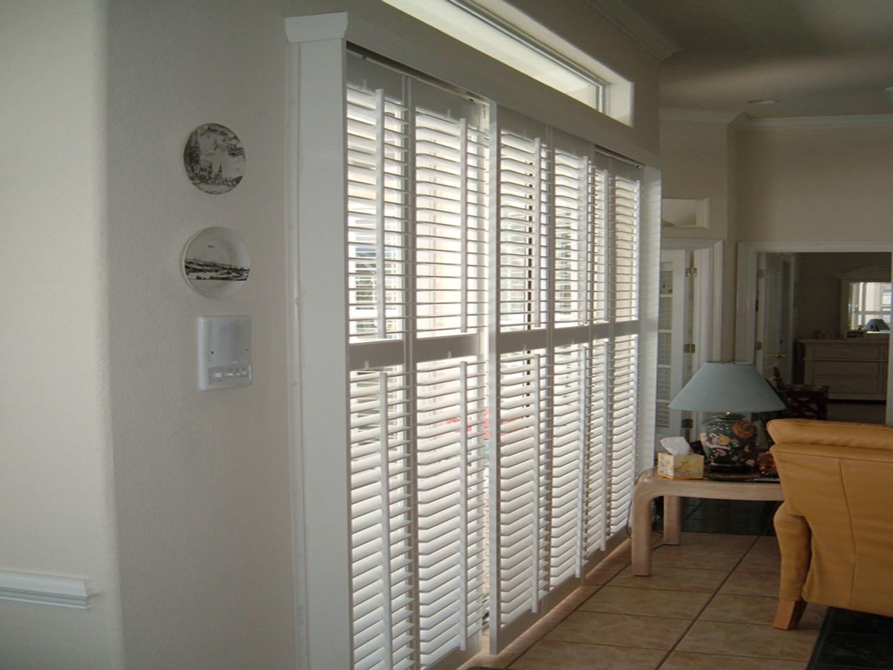 Side view of bypass plantation shutters on a sliding glass door