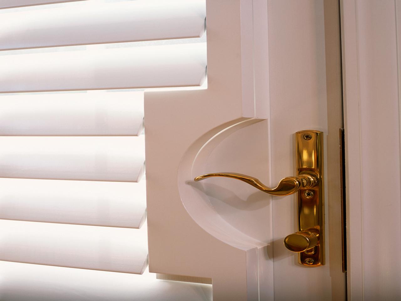 Close up of cut out on French door with plantation shutters