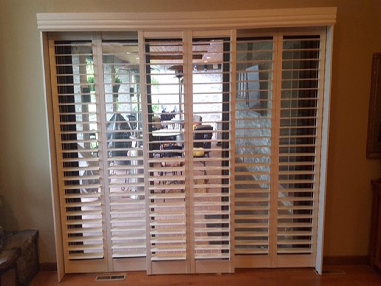 Bypass interior shutters with shutters covering the sliding glass doors with louvers open