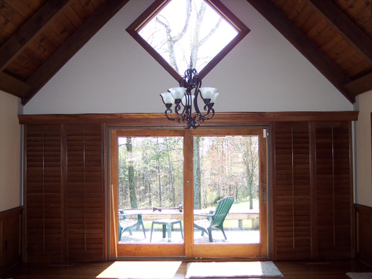 Sliding glass doors with bypass plantation shutters away from the windows