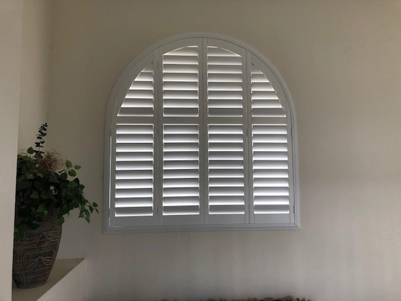 Arched window with shutters