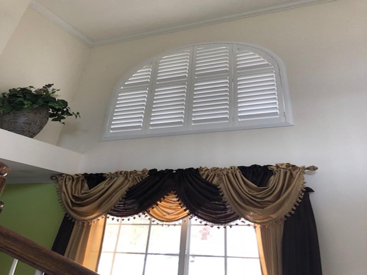 Arched windows with Louverwood plantation shutters