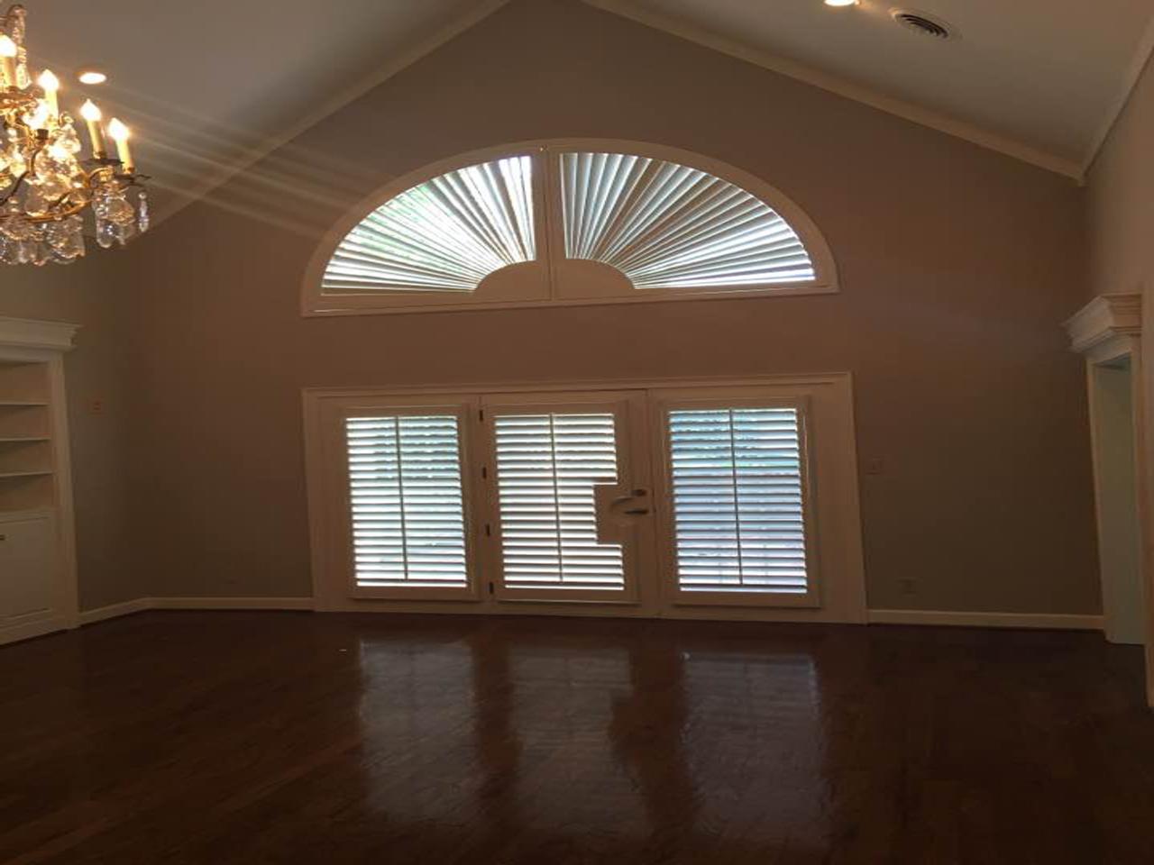 French doors and arched windows with shutters