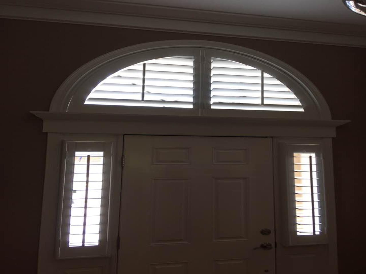 Arched shutters and sidelights covered with shutters