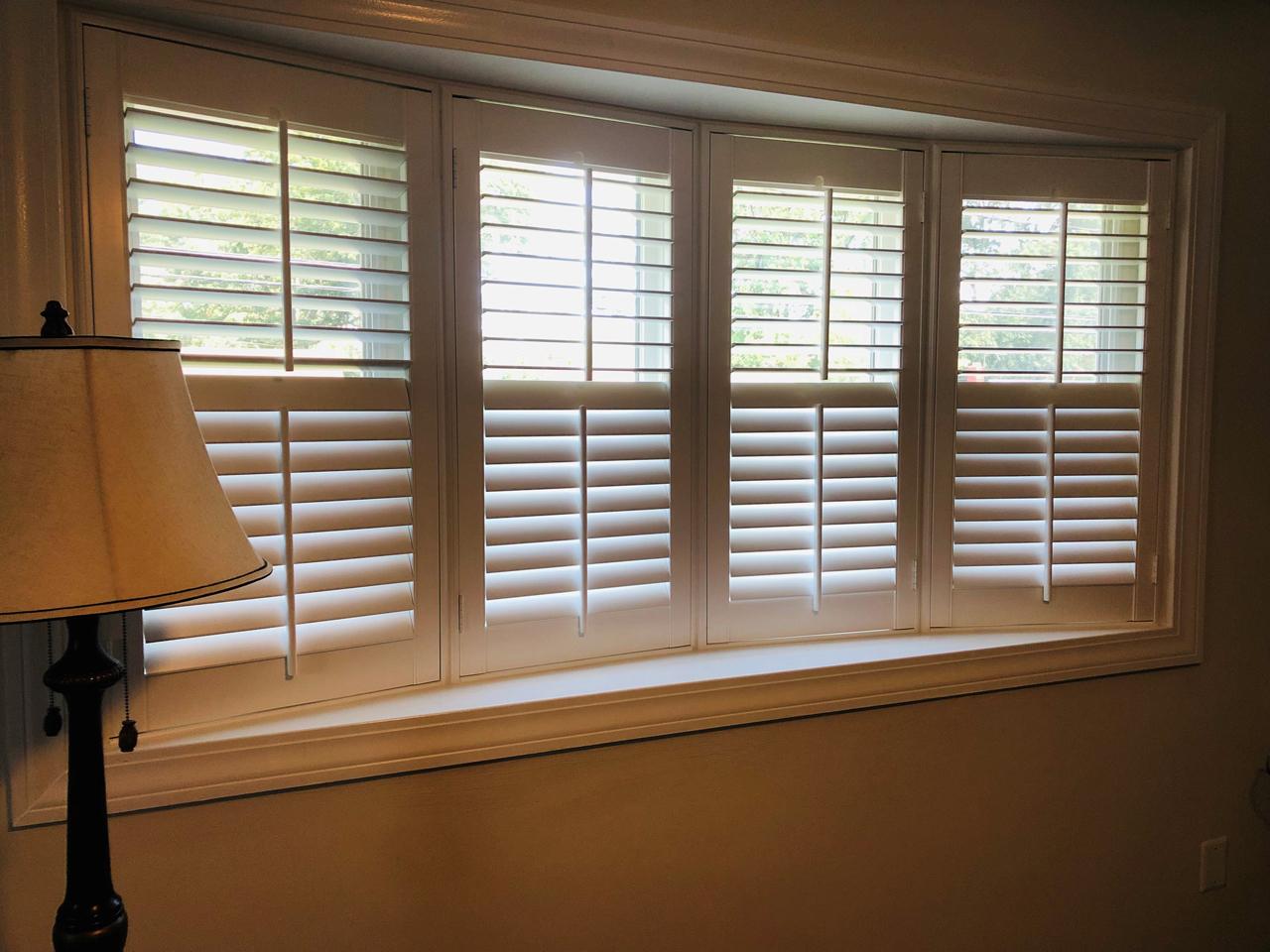 Classic wood shutters on bay window