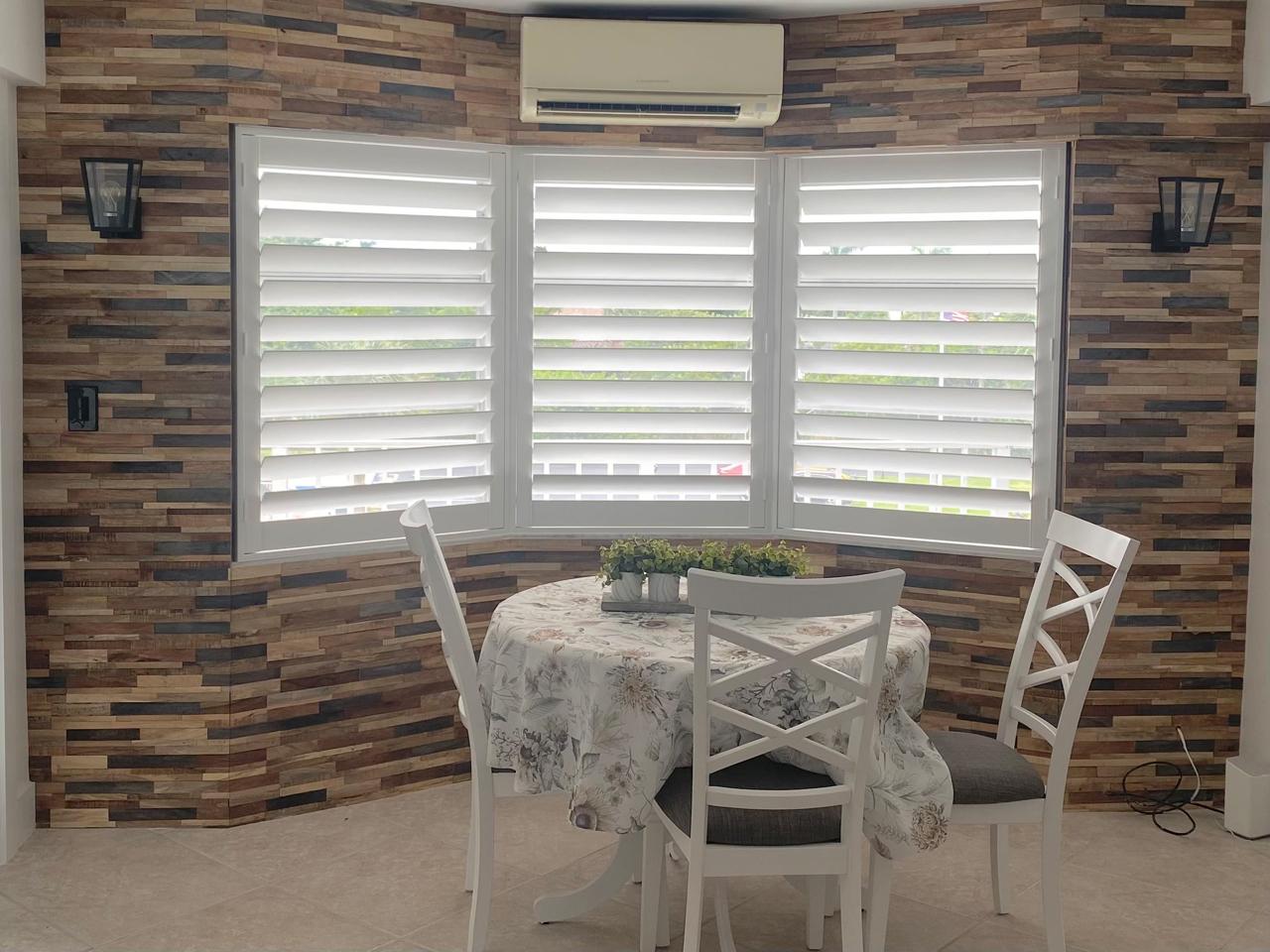 Bay windows with shutters by dining table