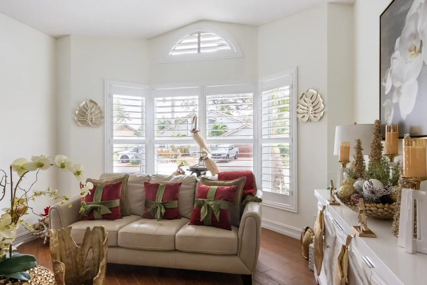 Christmas-time living room with shutters on bay windows
