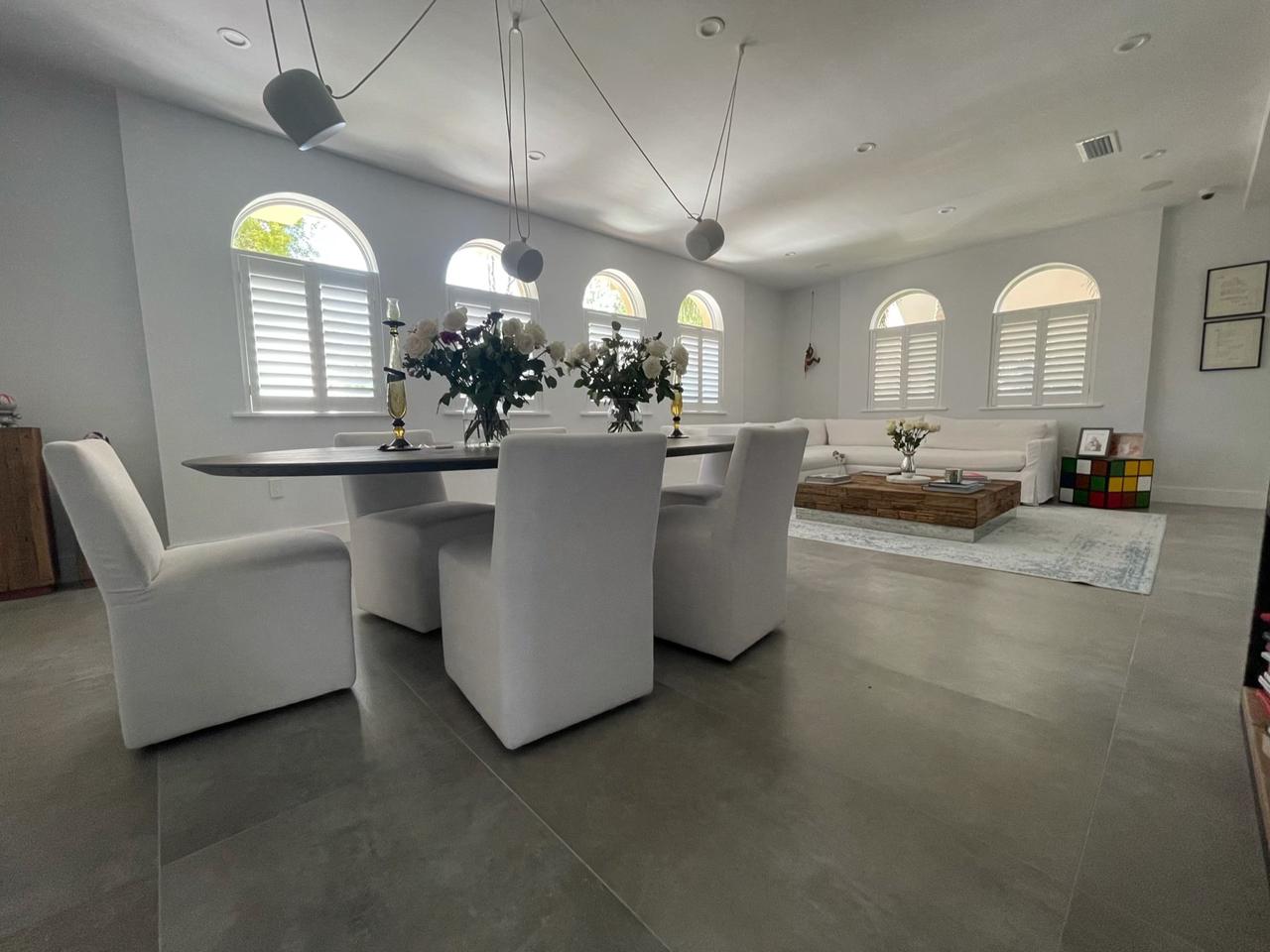 Open concept dining and living room with shutters